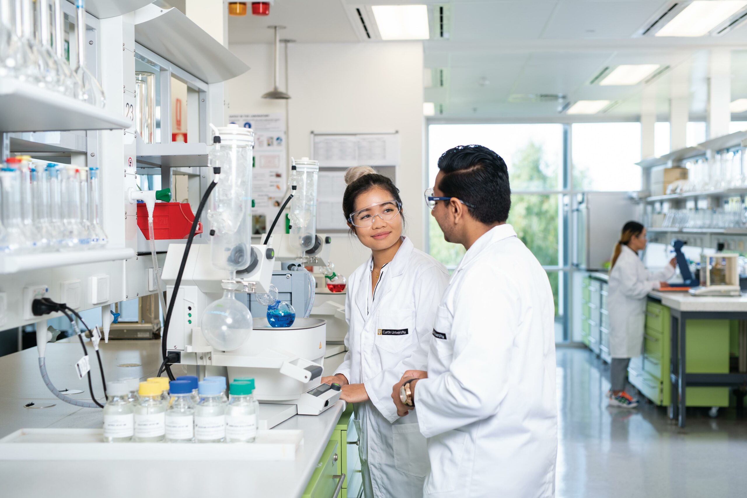 Male and female chemical science researchers in a lab setting