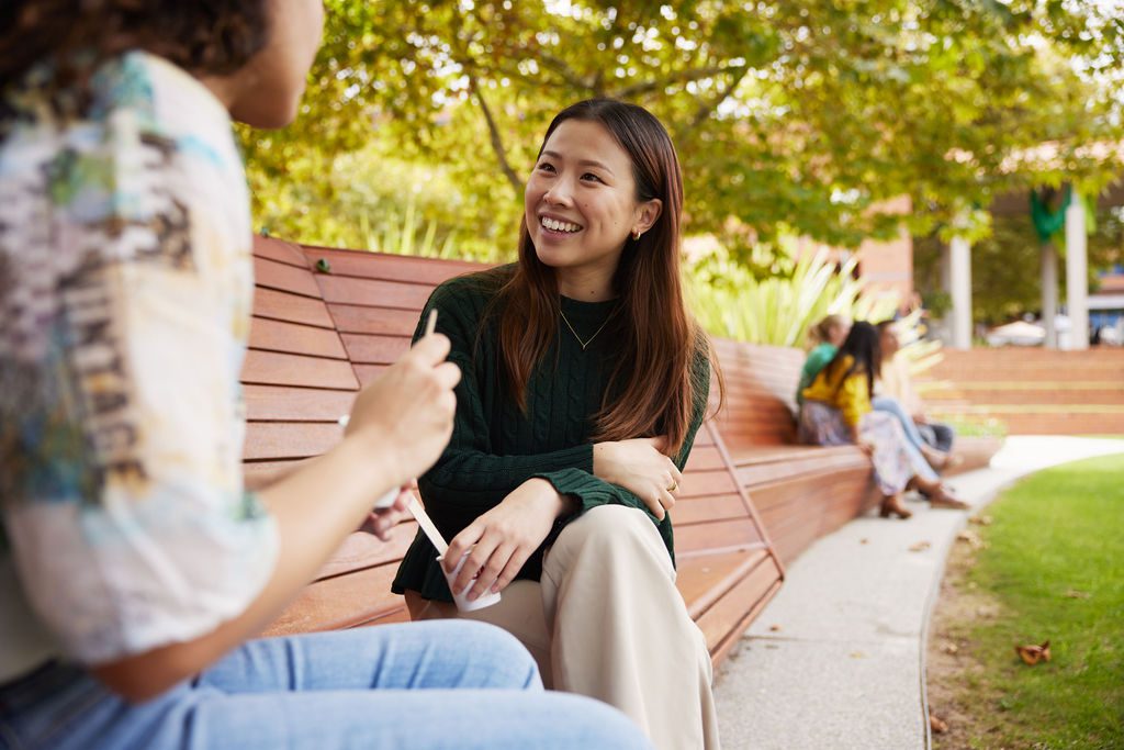 Female student sitting outside on bench