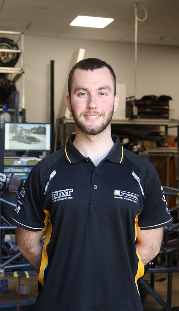 White male standing wit hhand sbehind back