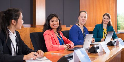 Staff members at a meeting in the Council Chambers