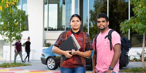 Two aboriginal students, standing in front of the camera