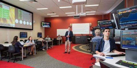 Students working in a stock market trading room