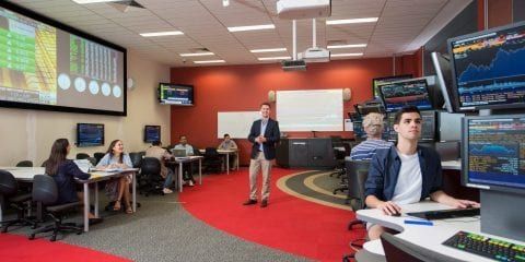 Students working in a stock market trading room