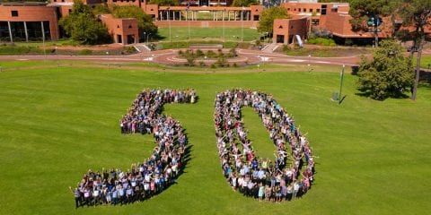 Staff forming the shape of a 50