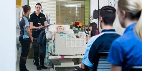 Nursing students working in a simulated hospital ward