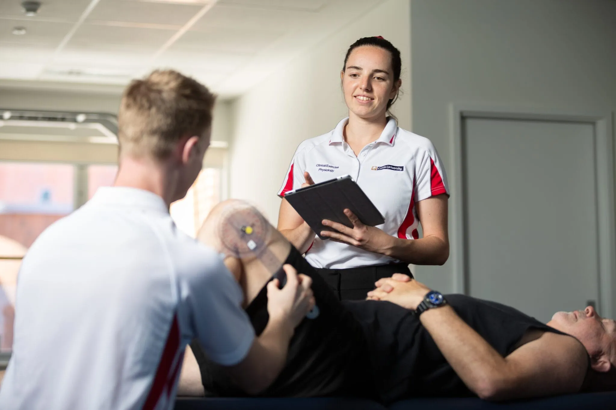 Allied health students working with a patient