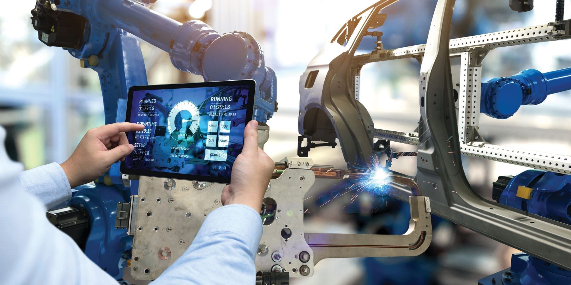 Man using tablet computer while building vehicle