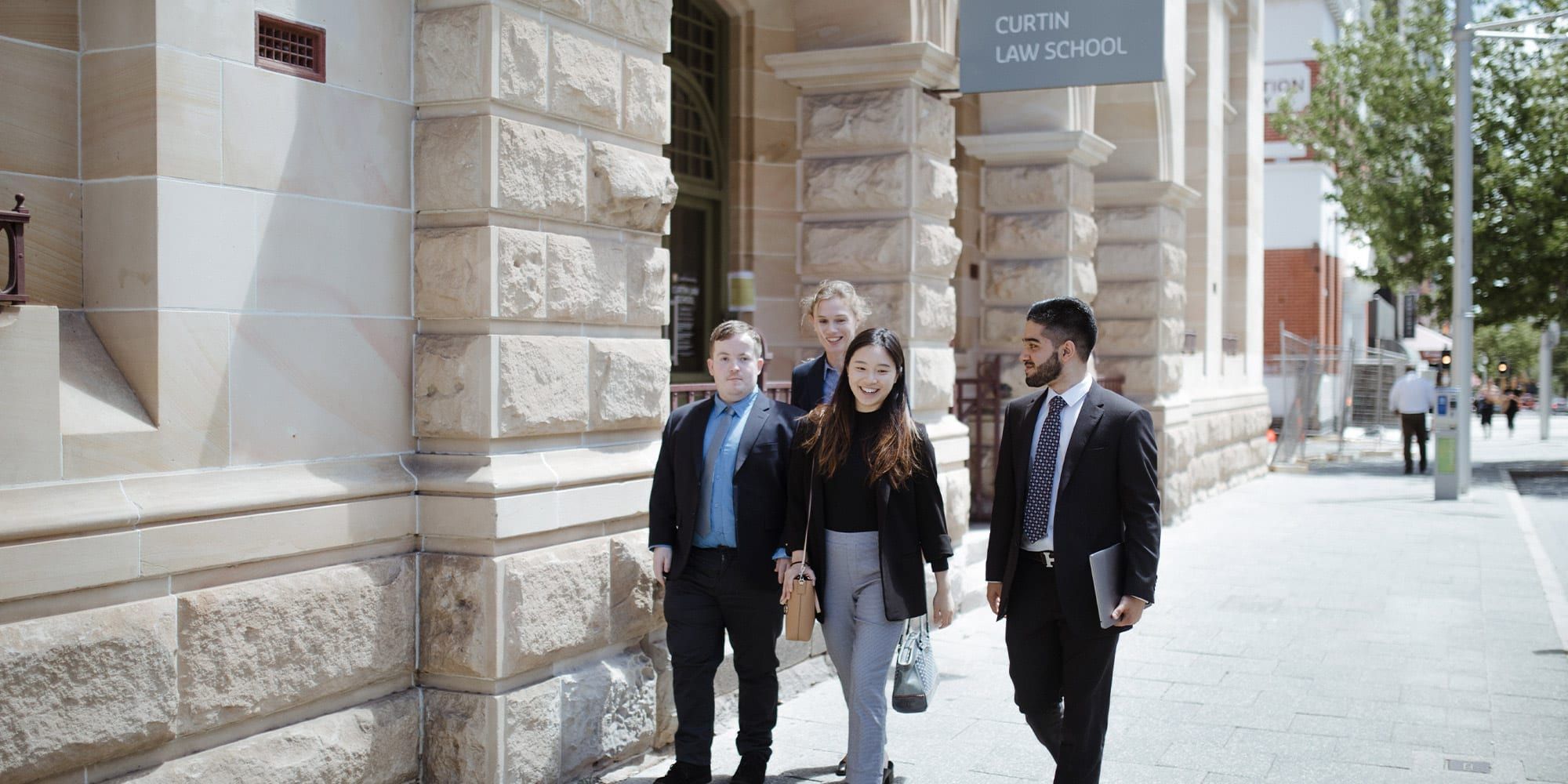 A group of four students leaving the Curtin law school in the city