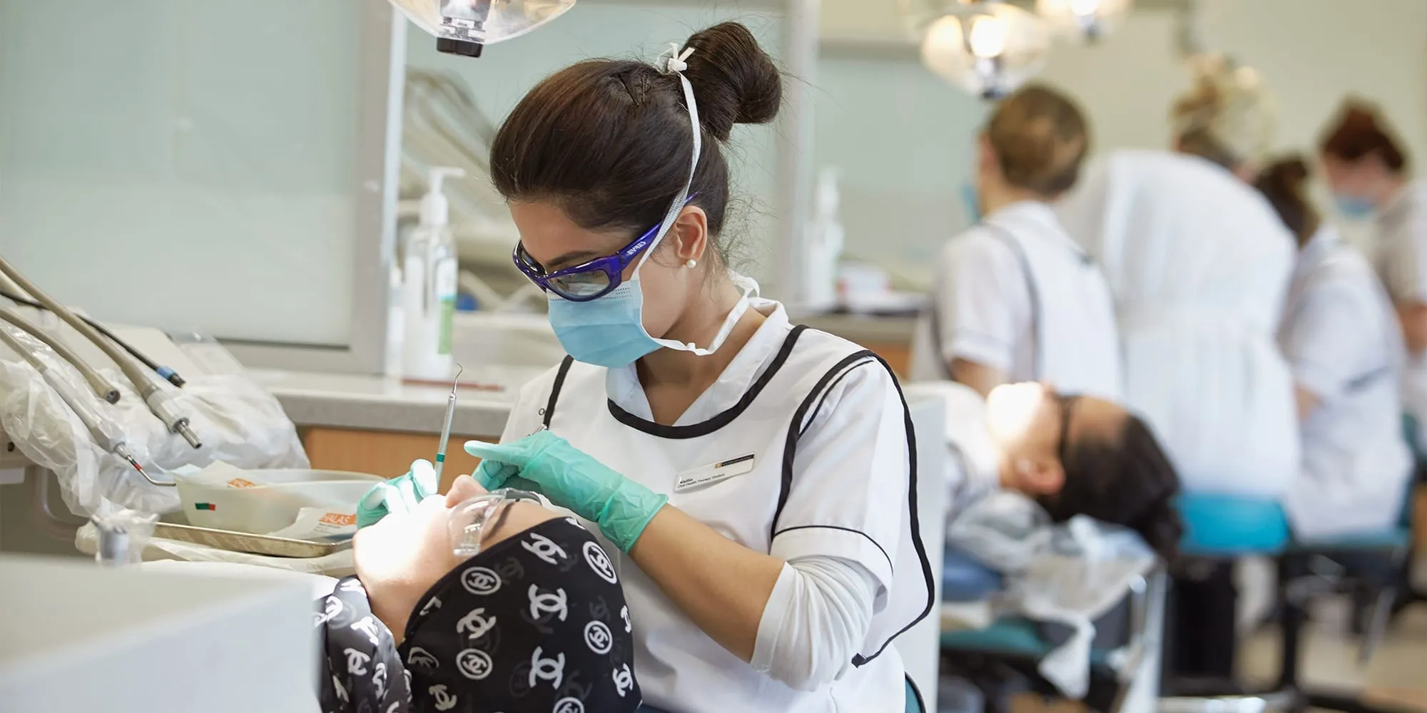 Oral health student working on a patient in clinic