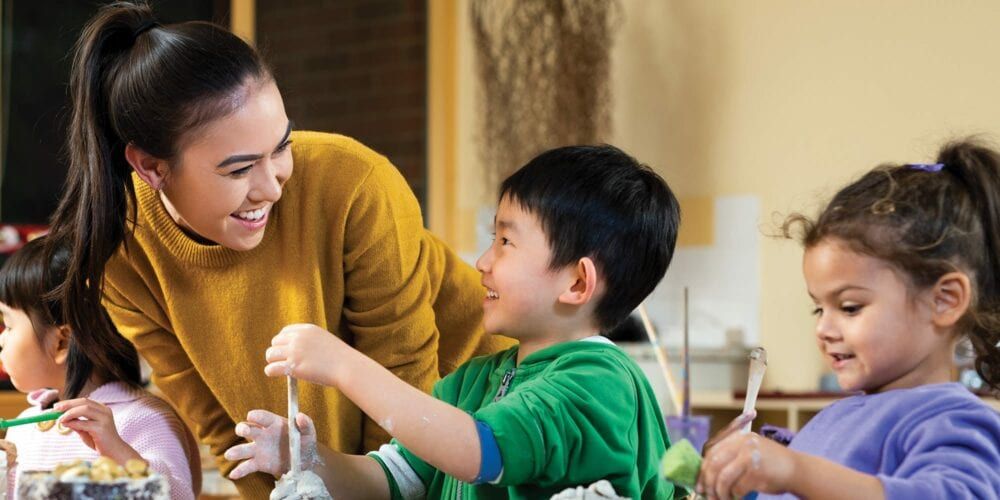 Female education student teaching primary school students