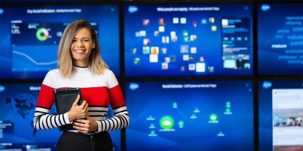 Marketing student standing in front of data screens in the agency