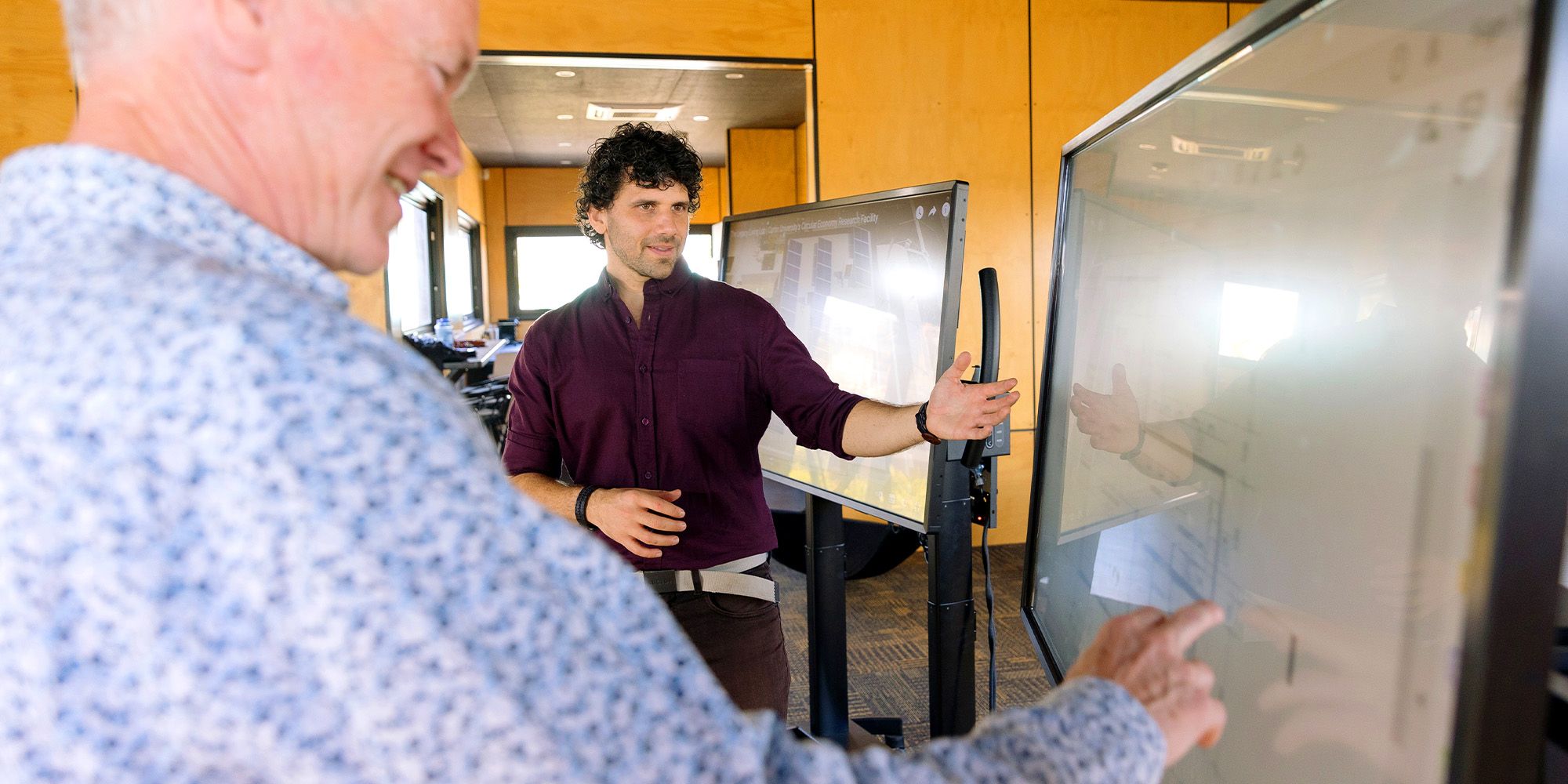 Curtin researchers writing on whiteboards