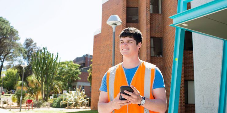 student wearing a orange vest