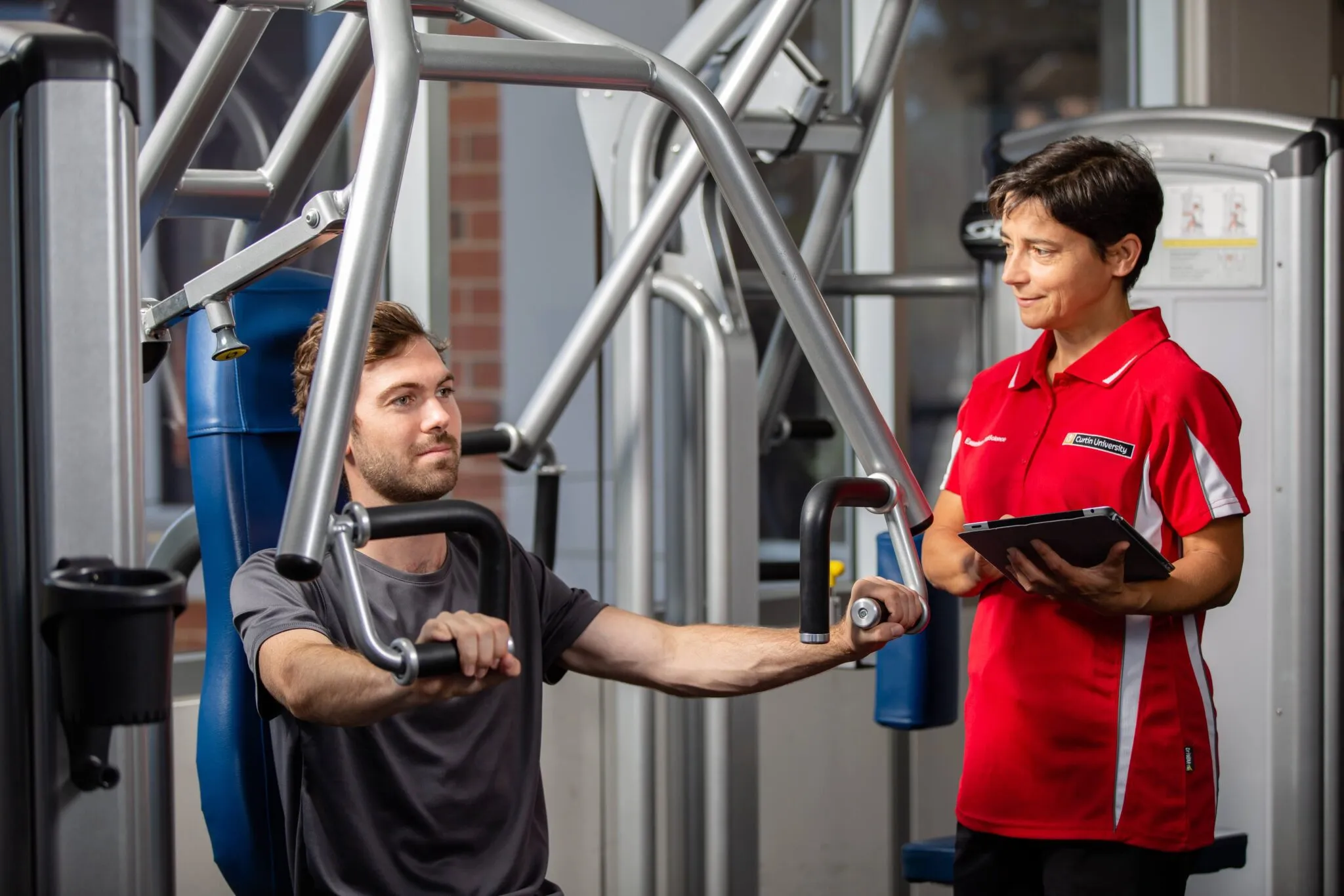 man exercising with an arm weight machine