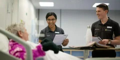 Curtin university students reading results to a patient