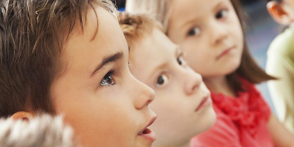 closeup of children from side as they look up