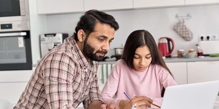 Father and daughter looking at a lap top
