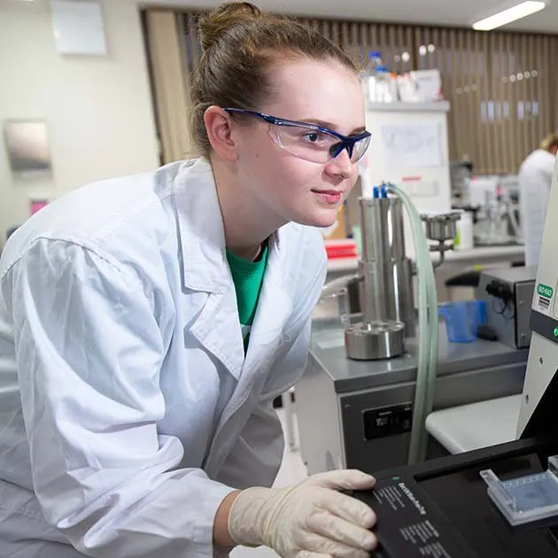 medical student, female, looking at screen of machine