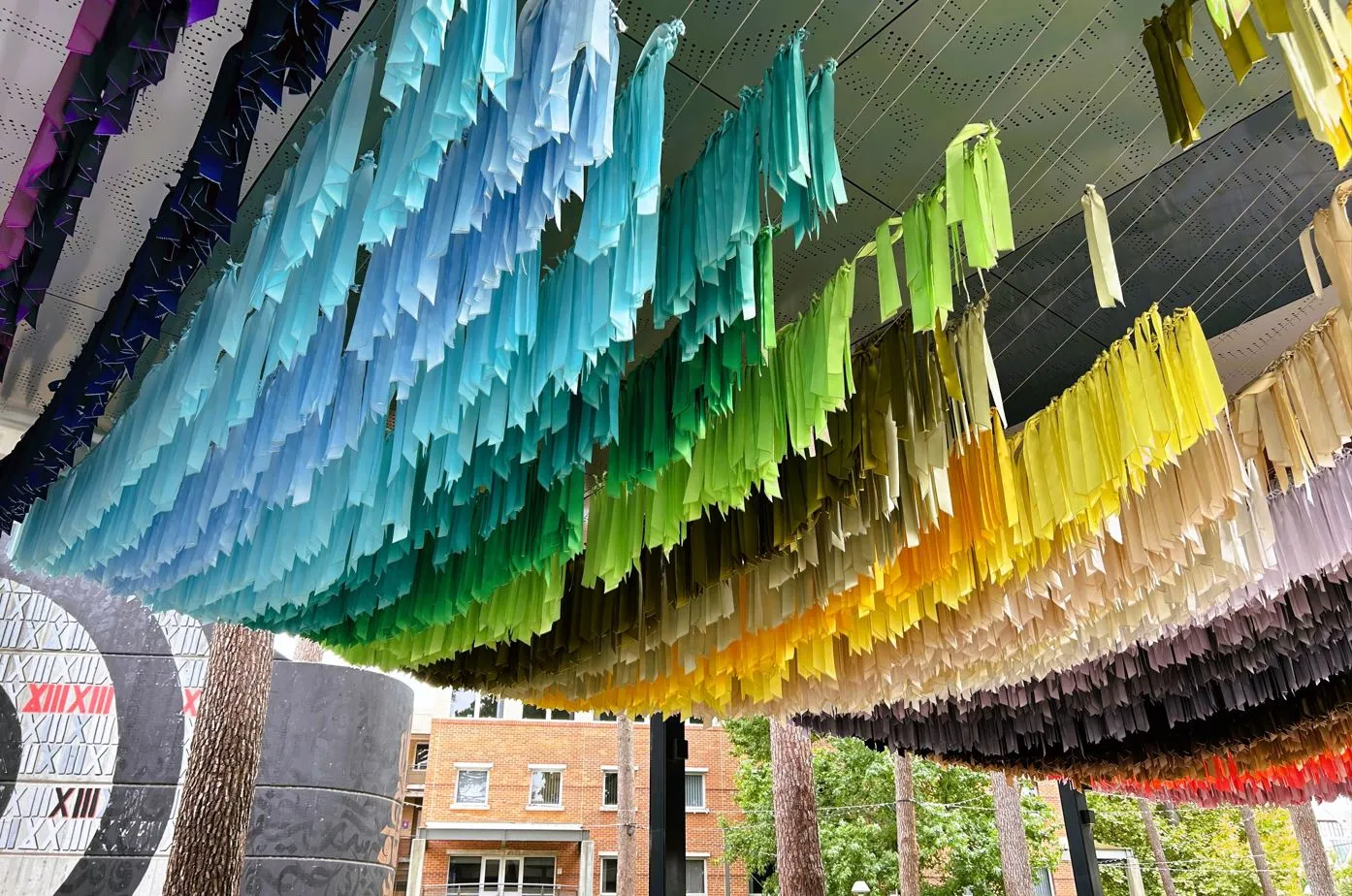 Rainbow ribbons hang from the ceiling of an undercover area in the Curtin Bentley campus Creative Quarter.