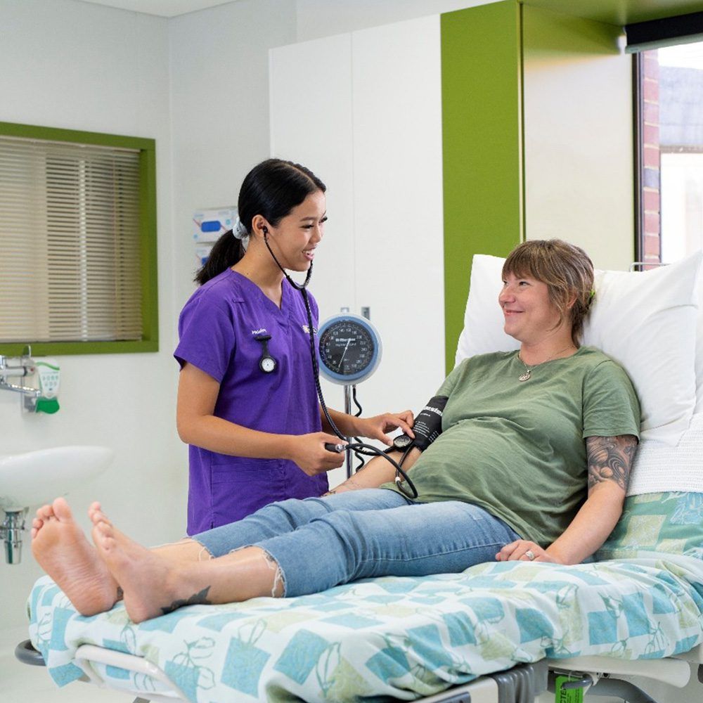 Midwife assessing pregnant woman
