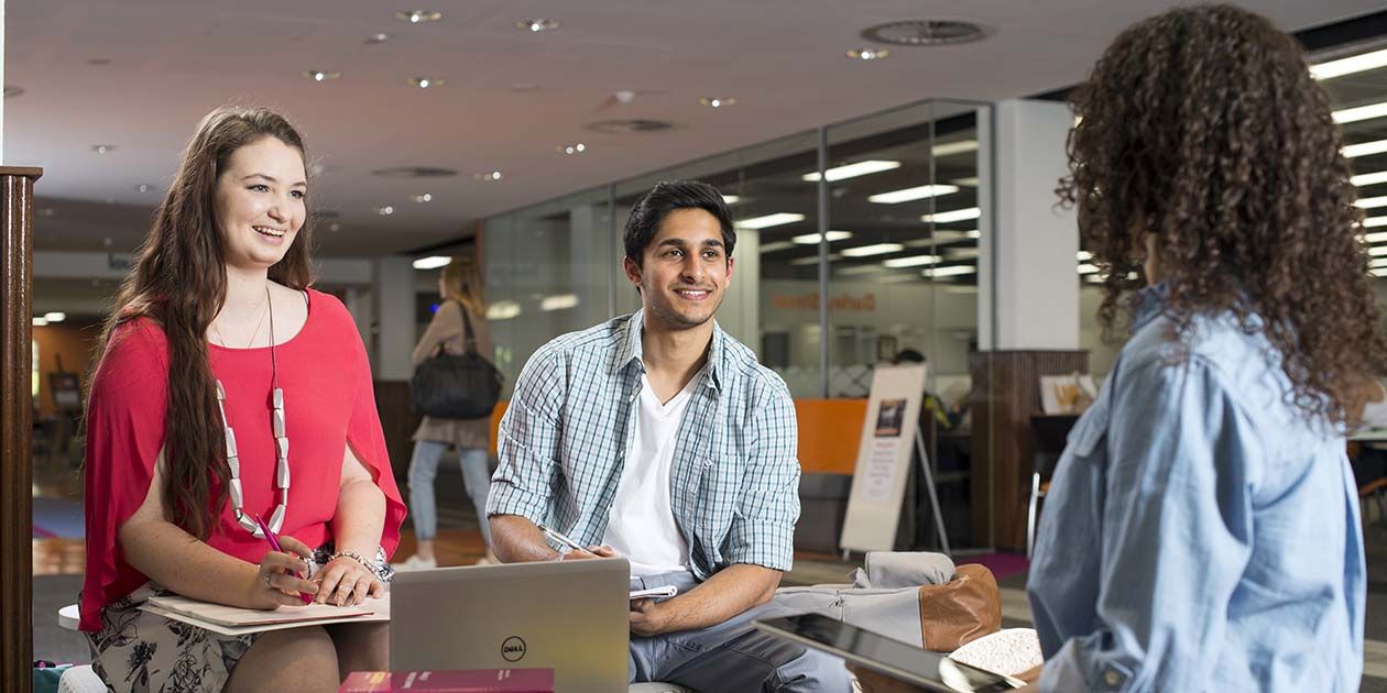 Group of students interacting on campus, in facilities, Campus life