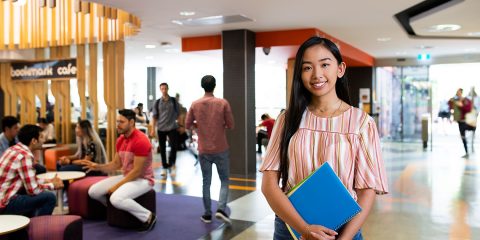 Student standing in library