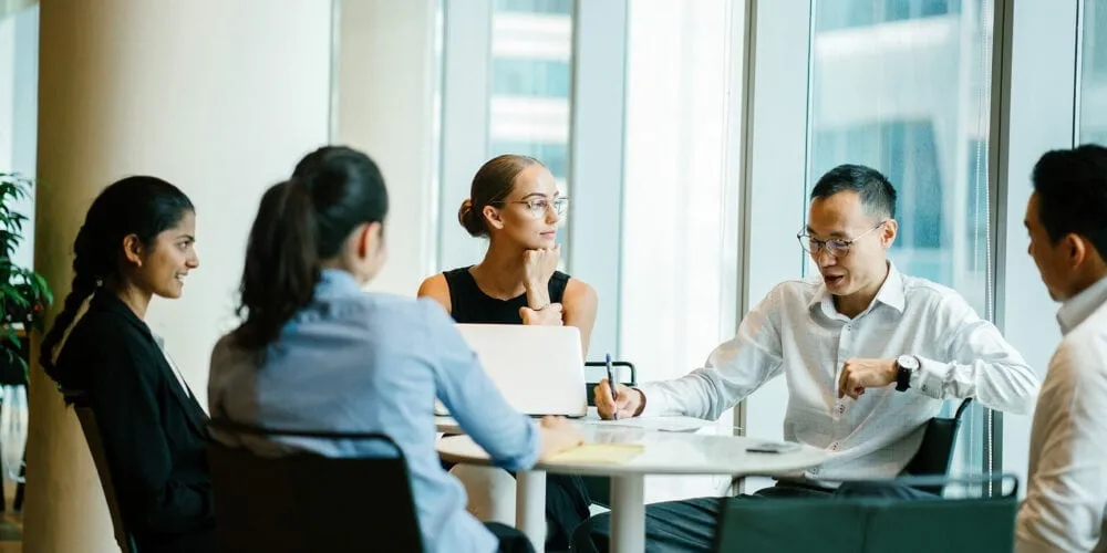 A group of business professionals sitting around a table