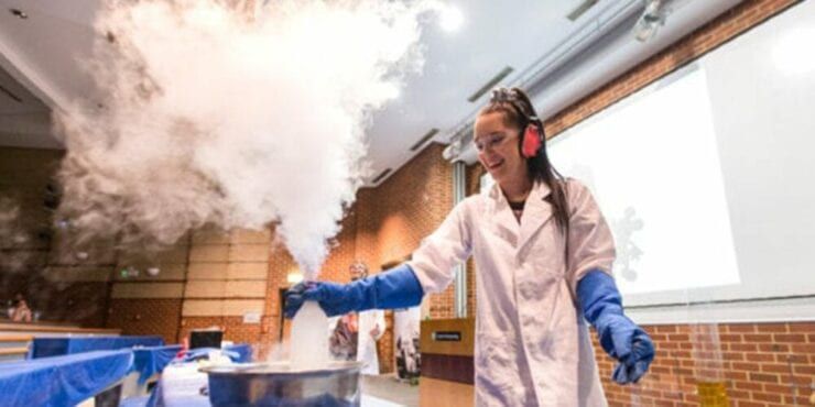Student in a lecture theatre participating in a STEM outreach demonstration