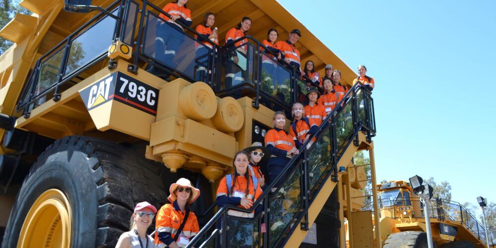 Group of students in front of mining truck