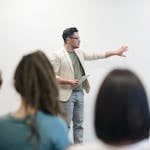 Man in Beige Blazer Holding Tablet Computer