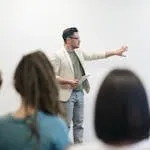 Man in Beige Blazer Holding Tablet Computer