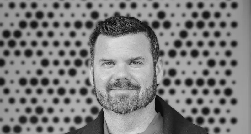 Black and white headshot of Tom Young, Founder of uDrew