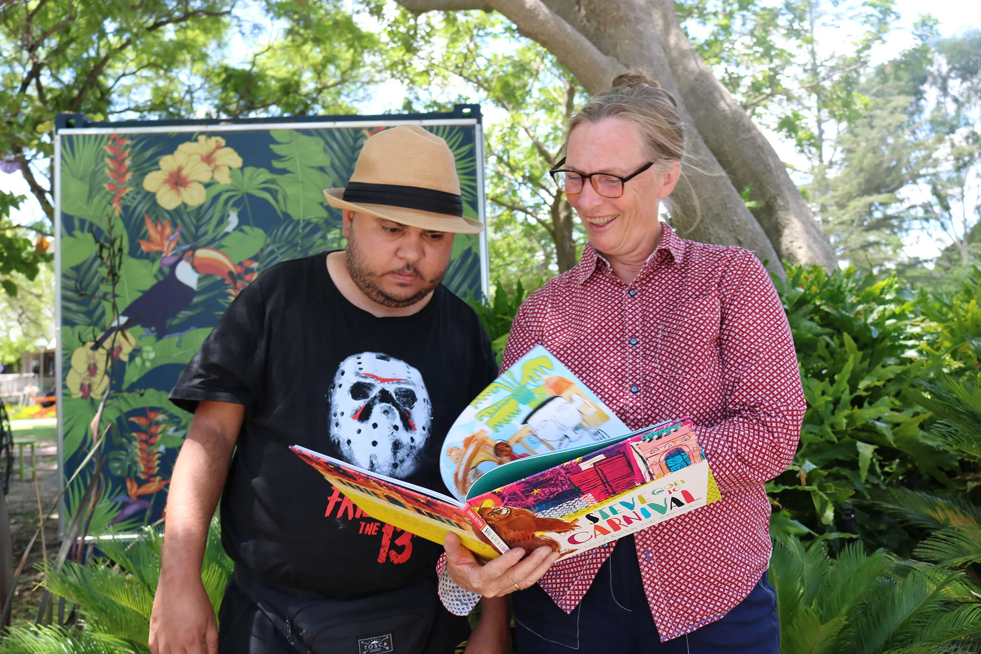 Woman flipping through a book with a man.