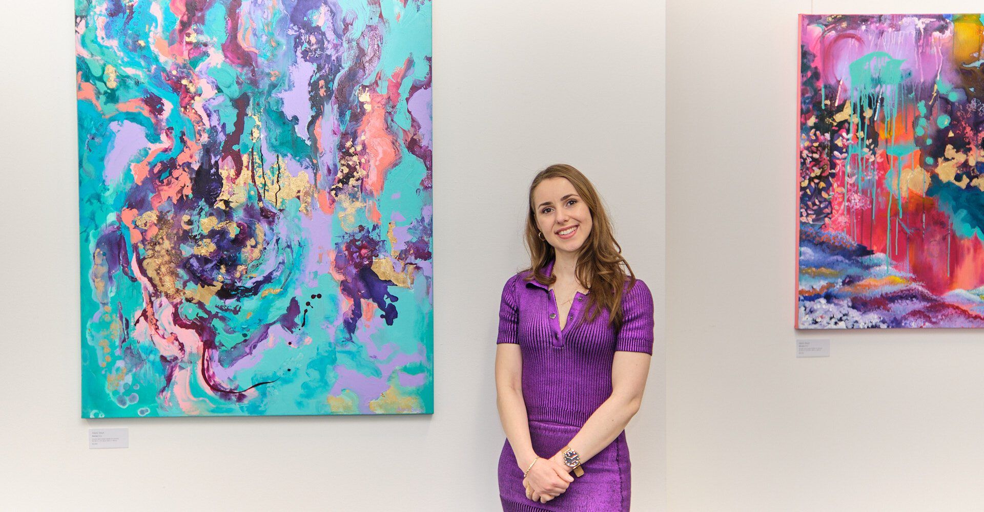 Alexis Steyn standing with painting