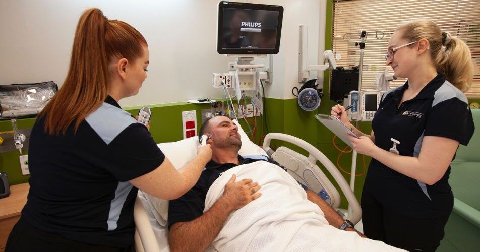 Curtin nursing students with a patient