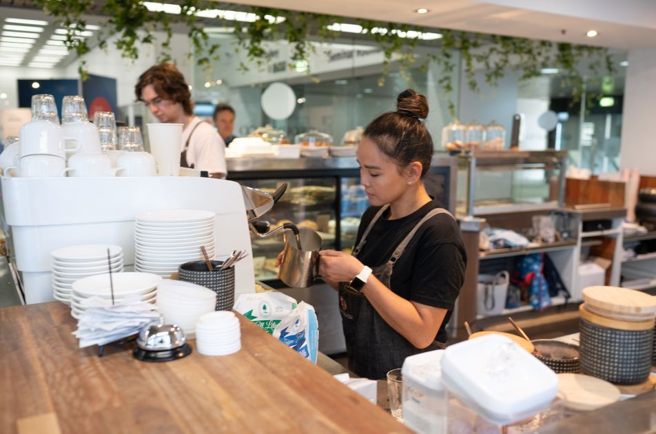 Curtin graduate Katie Liew pouring coffee