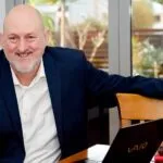 Curtin graduate and motivational public speaker Peter Dhu seated