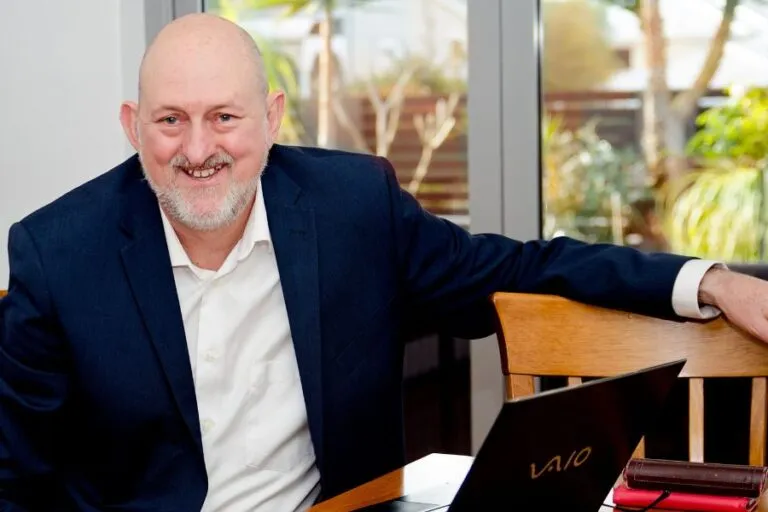 Curtin graduate and motivational public speaker Peter Dhu seated