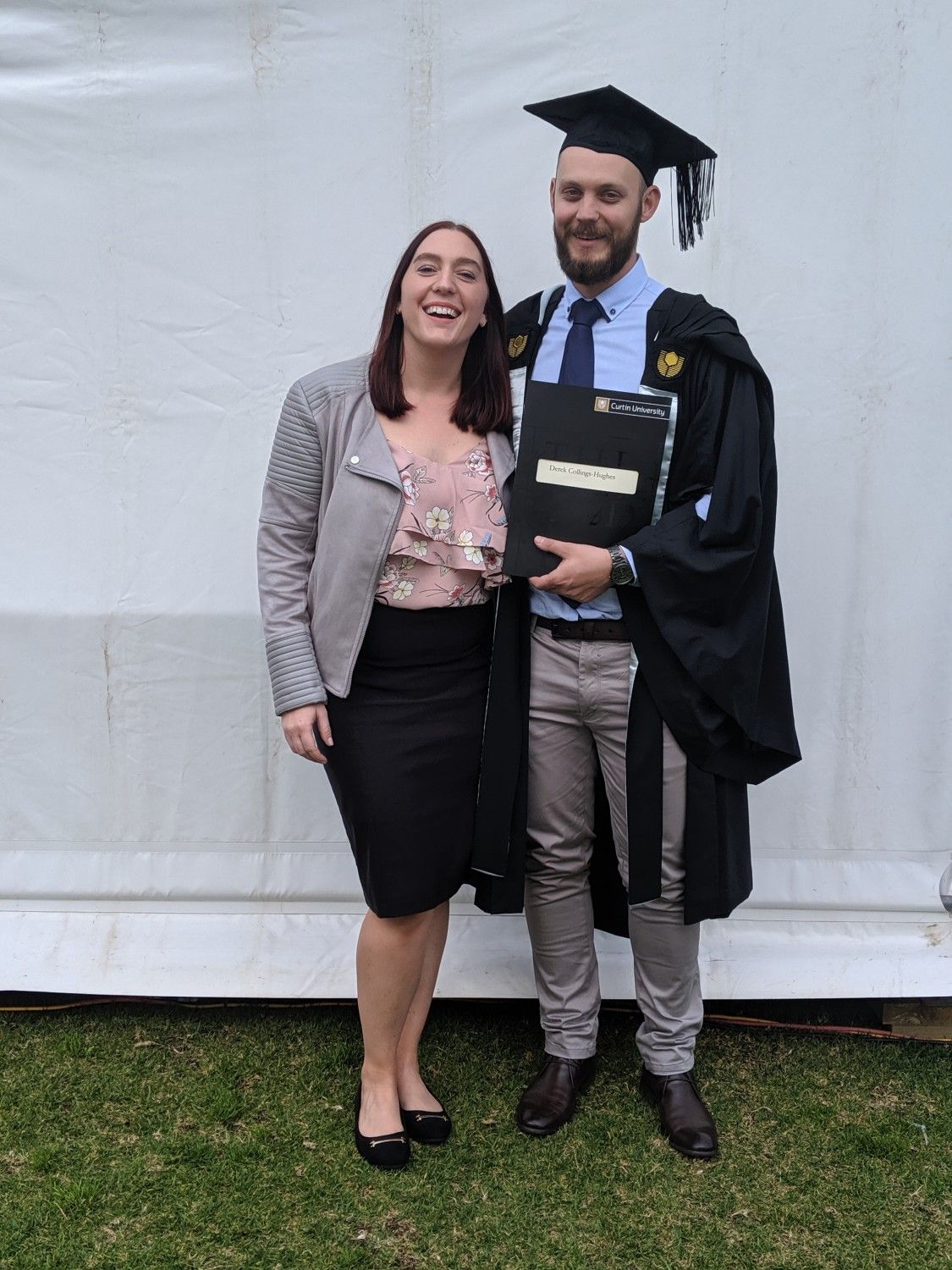 derek and his partner at his curtin graduation ceremony