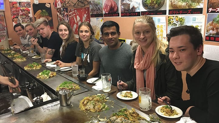 Tour group eating Hiroshima Okonomiyaki