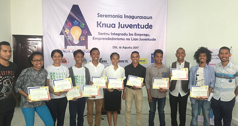 Timorese youth holding awards at the Knua Juventude youth centre.