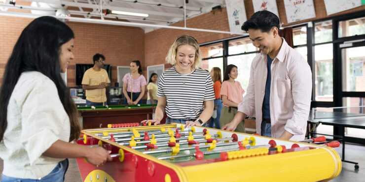 A group of students playing foosball in Curtin's accomodation facility