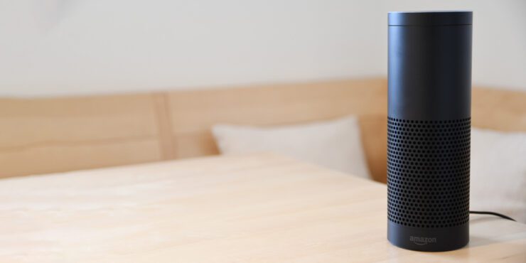 Amazon Alexa device on a wooden table.