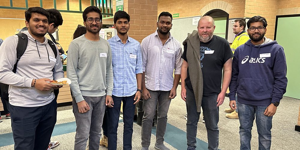 Group of students with an industry mentor at Curtin Kalgoorlie.