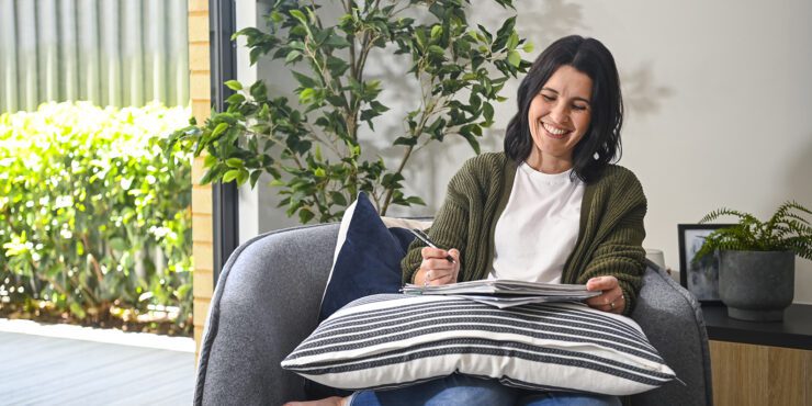 A student at home, writing in her notebook