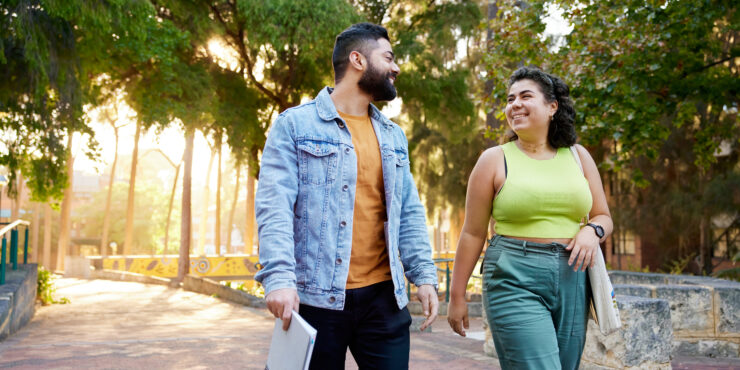 Two students walking through campus