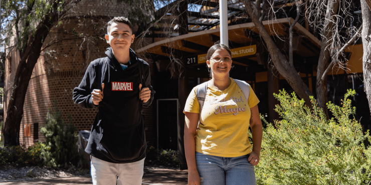 Two students standing in front of the Centre for Aboriginal Studies building.