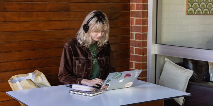 Student sitting at desk on device