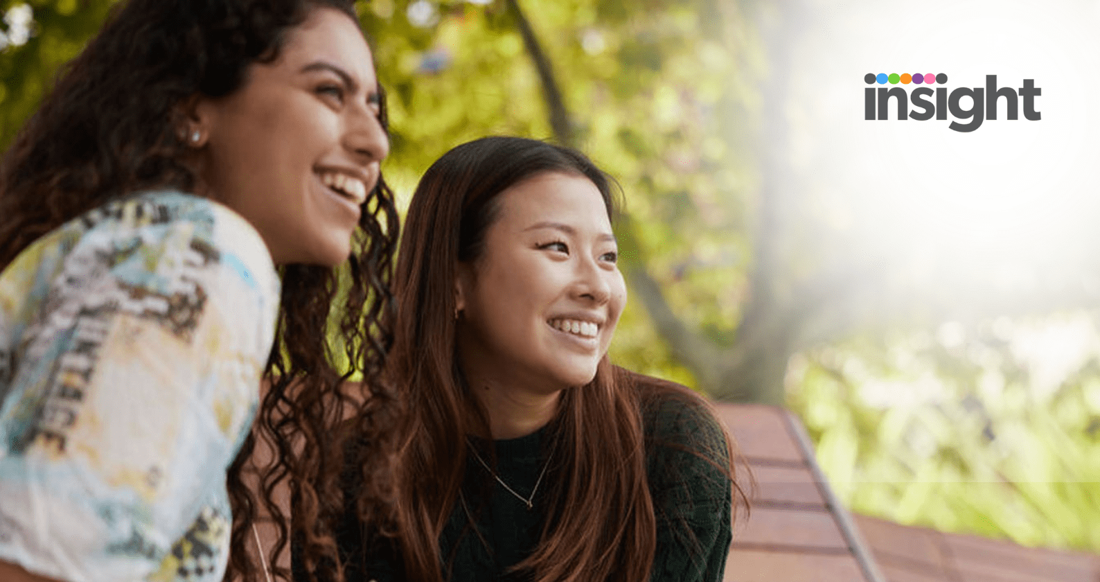 Two students smiling into the distance. The Insight logo is in the top right hand corner.
