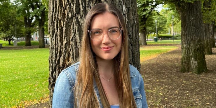 Brianna smiles at the camera whilst outside